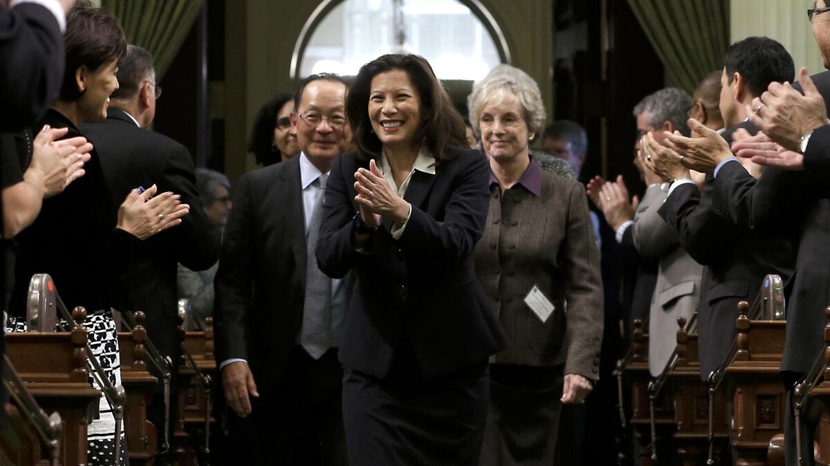 California Supreme Court Chief Justice Tani Cantil-Sakauye returns lawmakers' applause as she is escorted into the Assembly chamber to deliver her annual State of the Judiciary address before a joint session of the Legislature.