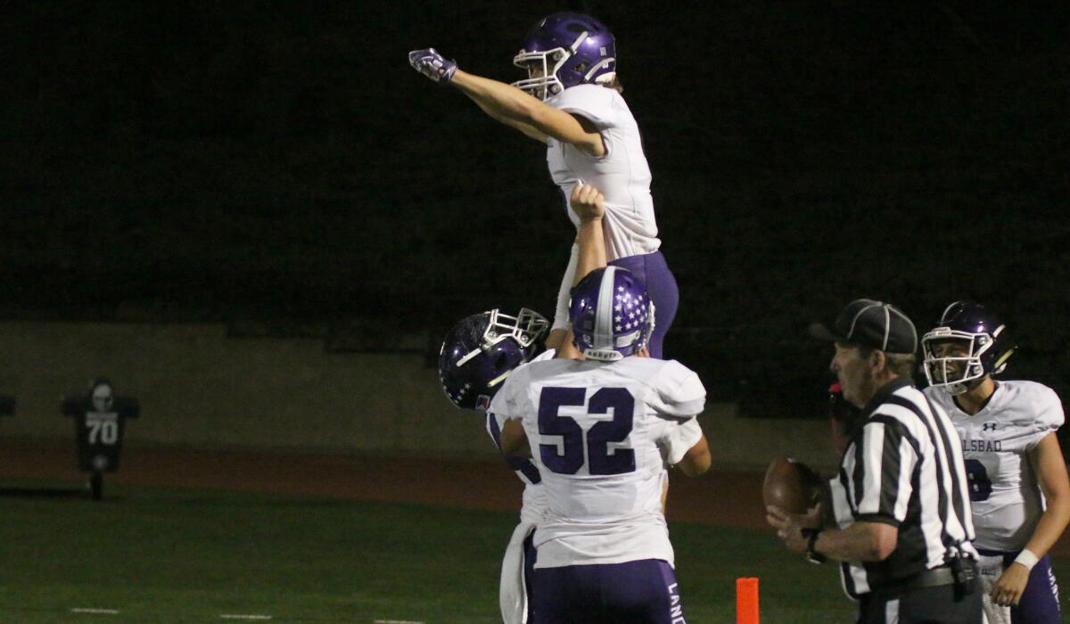The Lancers' Zach Chavez gets a lift from teammates after scoring the game-winning TD.