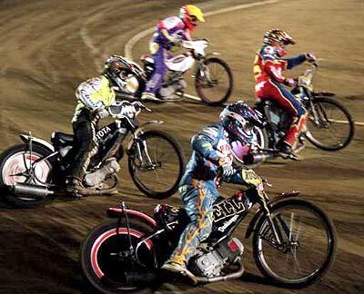 Bobby "Boogaloo" Schwartz, bottom, goes wide on the first lap at Costa Mesa Speedway.