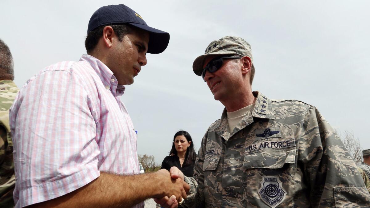 Puerto Rico Gov. Ricardo Rossello greets Gen. Joseph Lengyel, the head of the National Guard, after Lengyel's arrival at Camp Santiago on the island's southern coast on Sept. 27.