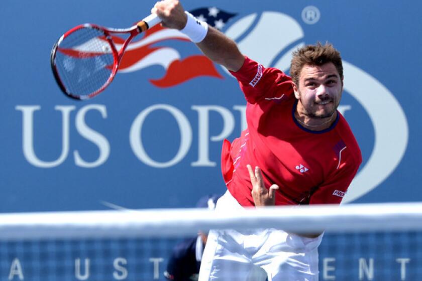 Stan Wawrinka serves against Andy Murray during their quarterfinal match Thursday at the U.S. Open.