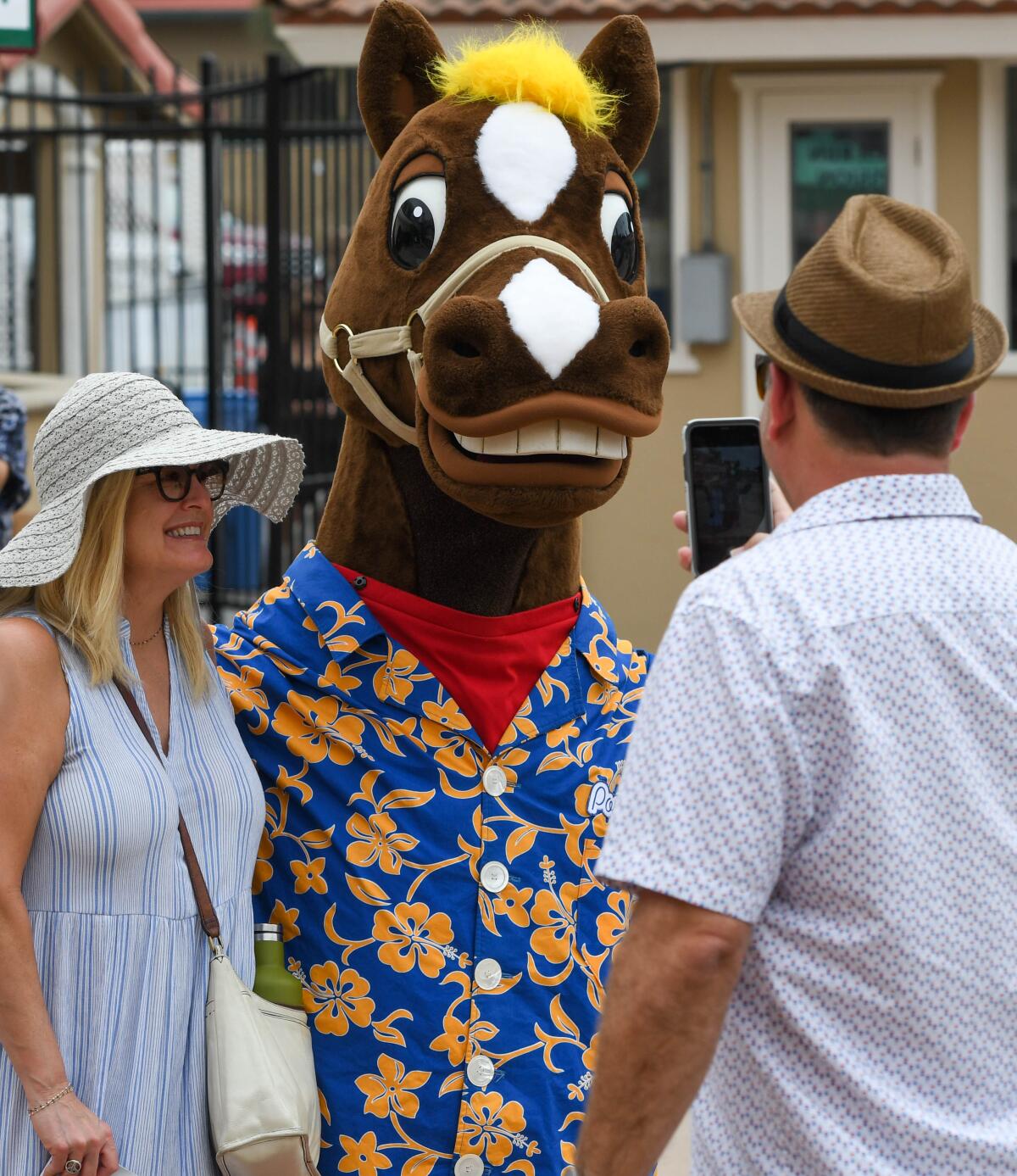 Del Mar's mascot, Pony Boy, mingles with the crowd and poses for pictures.