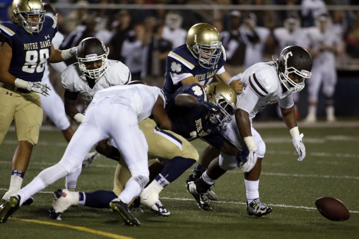 Crespi's Michael Mason (5) prepares to recover a Notre Dame fumble late in the second quarter. The Celts would drive for the go-ahead score before halftime.