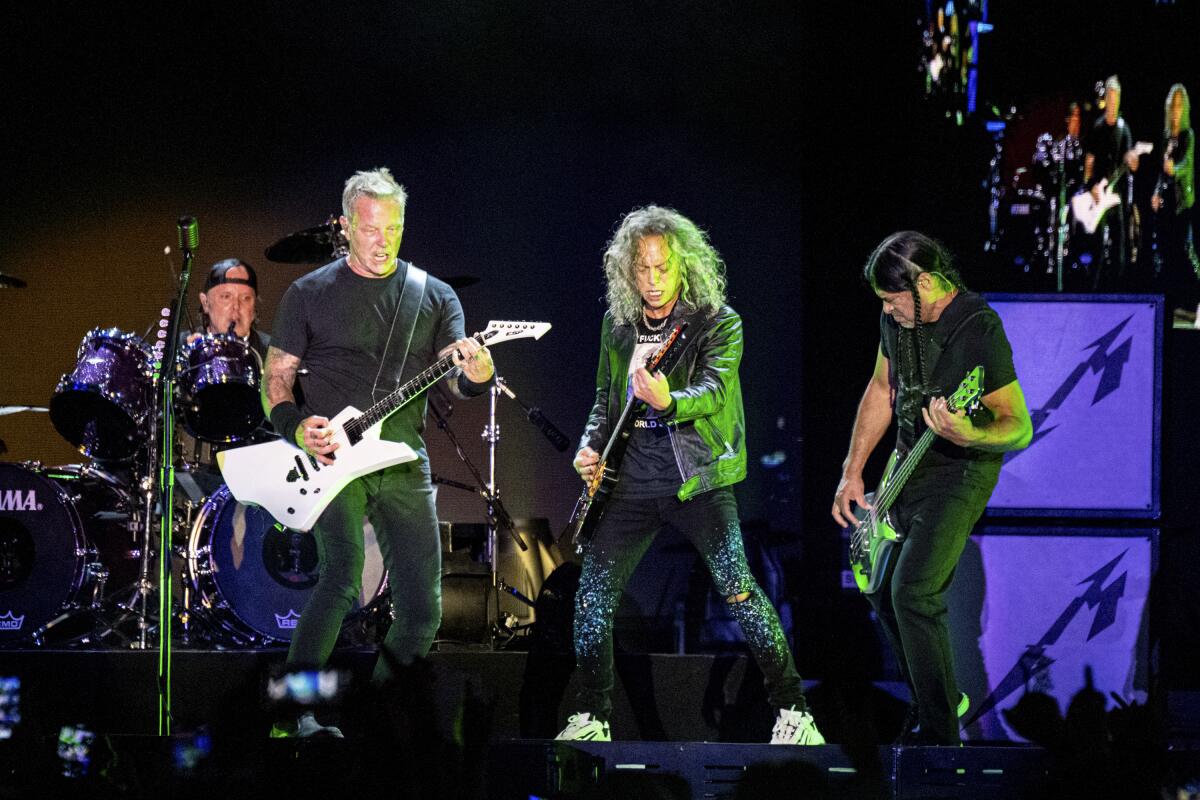 Metallica playing a set on stage at a festival