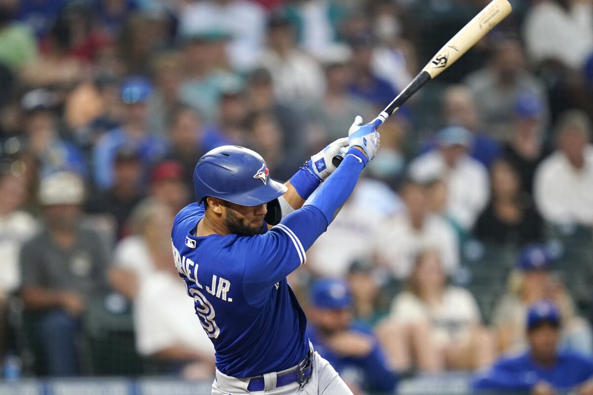 Toronto Blue Jays' Lourdes Gurriel Jr. singles in a pair of runs against the Seattle Mariners during the fourth inning of a baseball game Friday, Aug. 13, 2021, in Seattle. (AP Photo/Elaine Thompson)