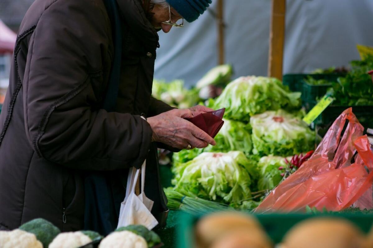 A shopper at a vegetable stand. When a vegan is dining at a friend's house, it is advised to bring one's own dish, especially a "naturally" vegan one, like a salad, rather than a vegan "meatloaf," which might be off-putting for the host.