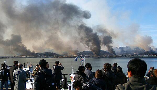 Plumes of smoke rise from Yeonpyeong island in the disputed waters of the Yellow Sea. North Korea fired artillery shells onto the South Korean island, killing two people, setting homes ablaze and triggering an exchange of fire as the South's military went on top alert.