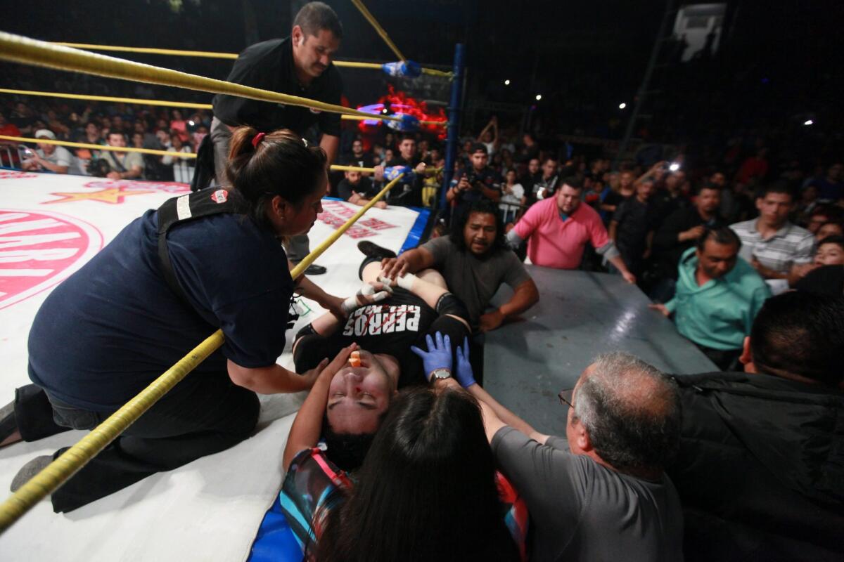 Perro Aguayo Jr. receives medical treatment.