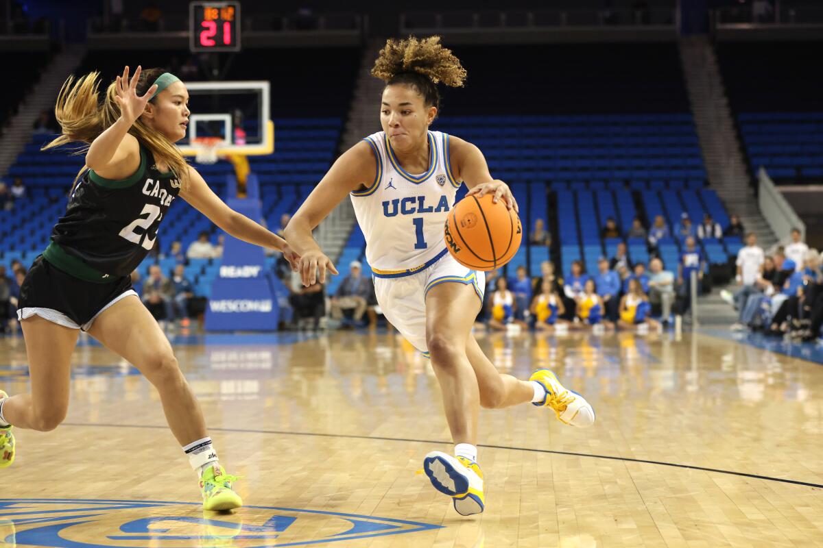 UCLA's Kiki Rice, right, drives to the basket in front of Cal Poly San Luis Obispo's Taylor Wu.