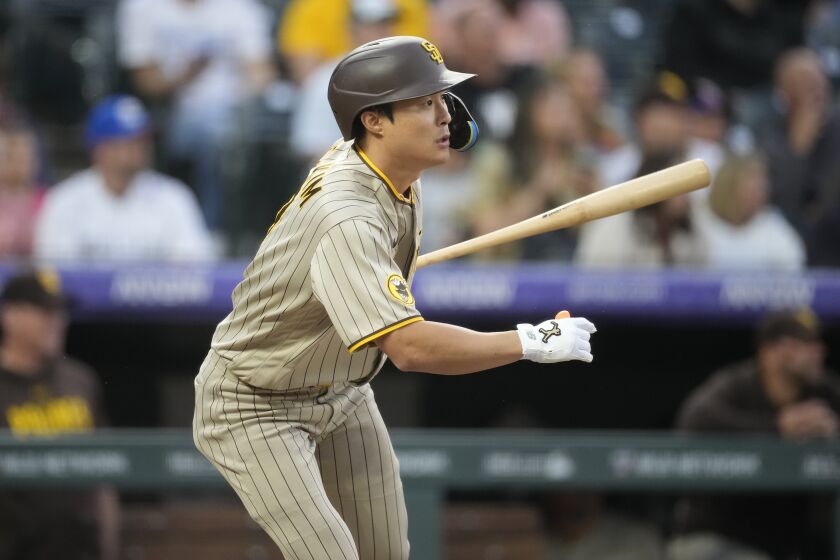 San Diego Padres' Ha-Seong Kim follows the flight of his RBI-single off Colorado Rockies starting pitcher Austin Gomber in the fifth inning of a baseball game Friday, June 9, 2023, in Denver. (AP Photo/David Zalubowski)