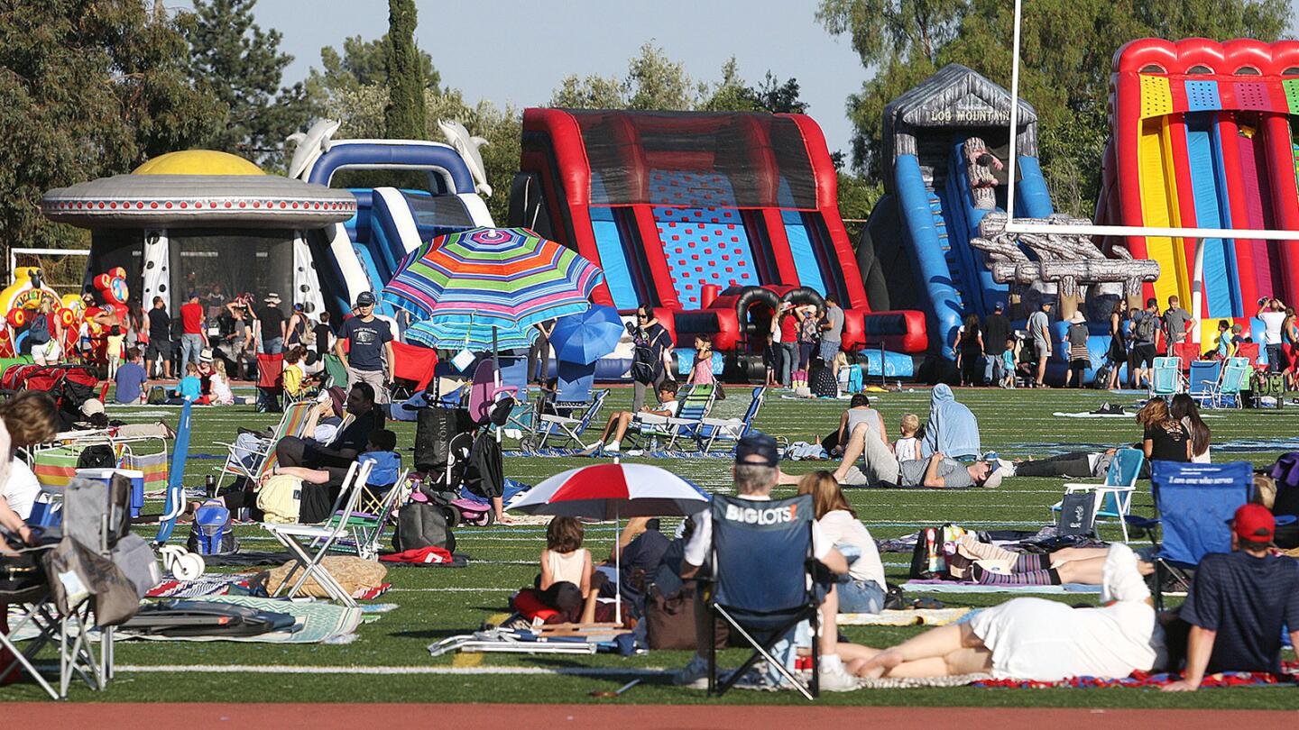 The football field at Crescenta Valley High School as it fills in with guests at the Fourth of July fireworks show on Tuesday, July 4, 2017. The pre-show, which started around 5:00, featured live bands, inflatable slides, and the entire football field to sit and get a nearly unobstructed view of the fireworks show later in the evening.