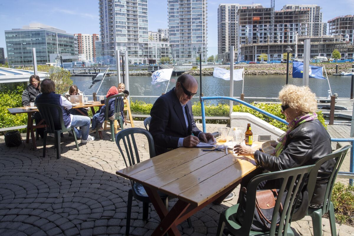 In May, patrons dine on a restaurant patio in Stamford, Conn.