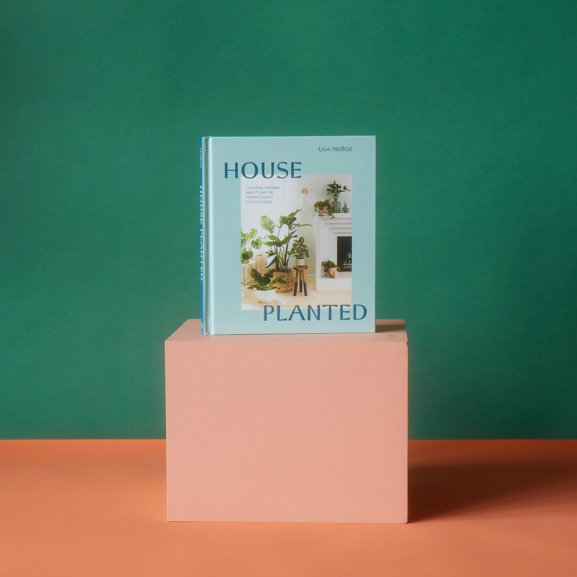 The book "House Planted" sits on a box.