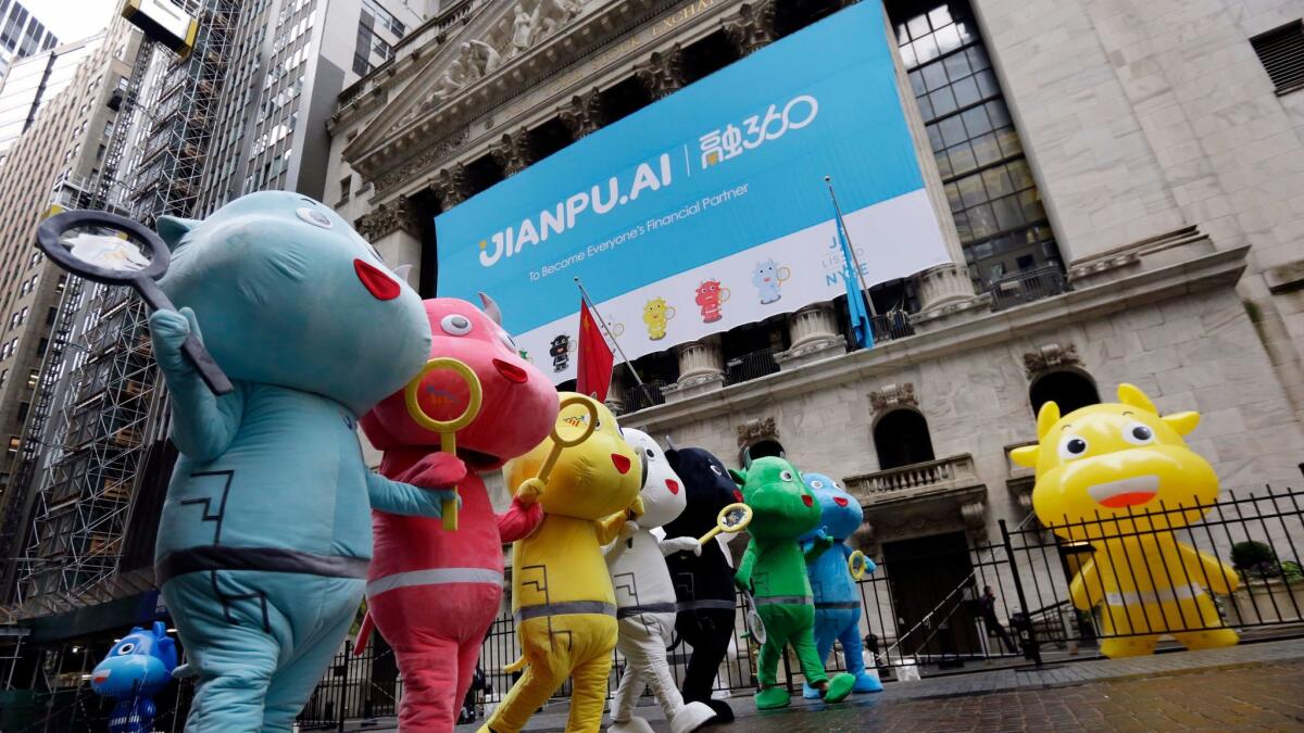 China's Jianpu Technology mascots parade outside the New York Stock Exchange as part of the company's IPO celebration.