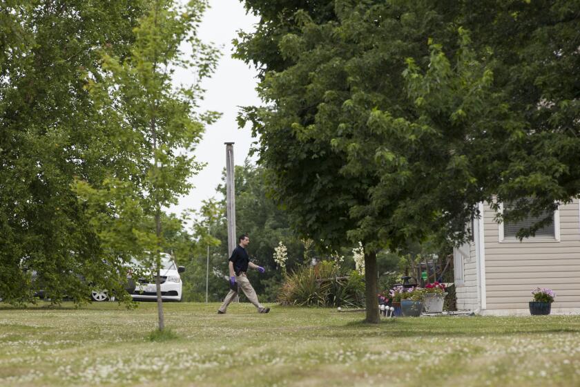 An investigator walks to the home of James Hodgkinson on June 14, 2017 in Belleville, Ill.
