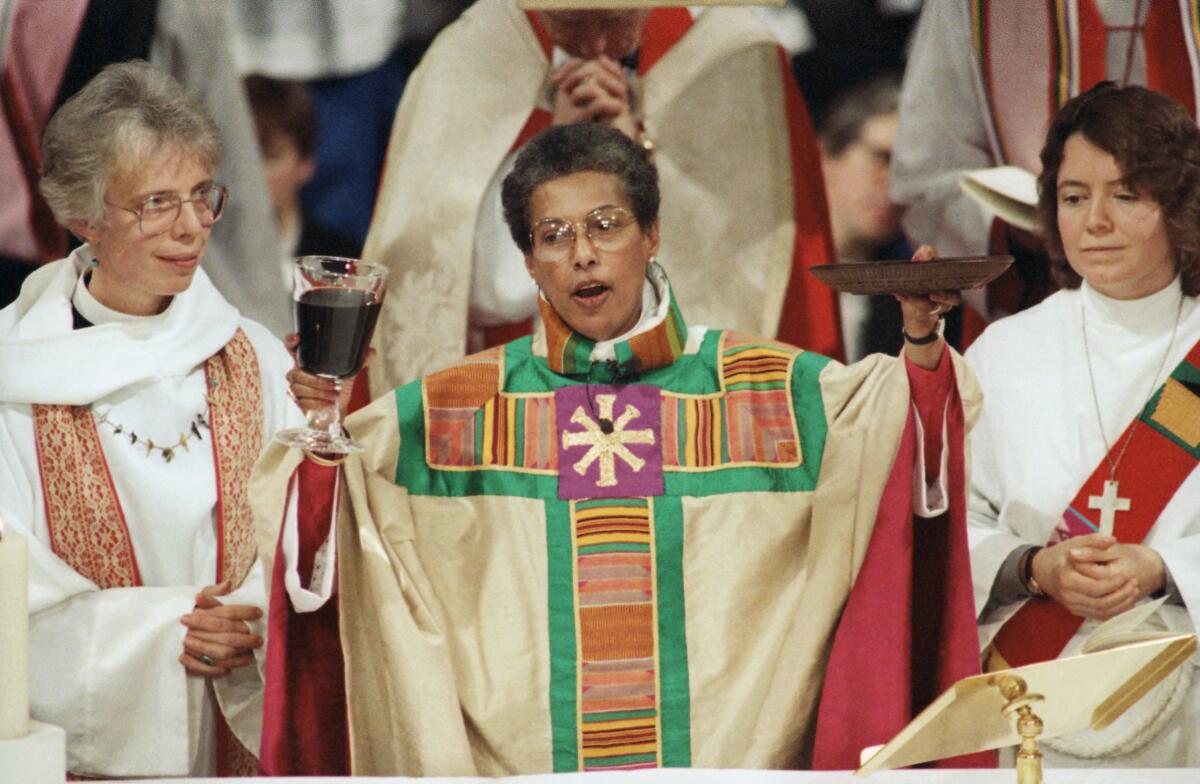  A woman in priest's robes celebrating the Eucharist 