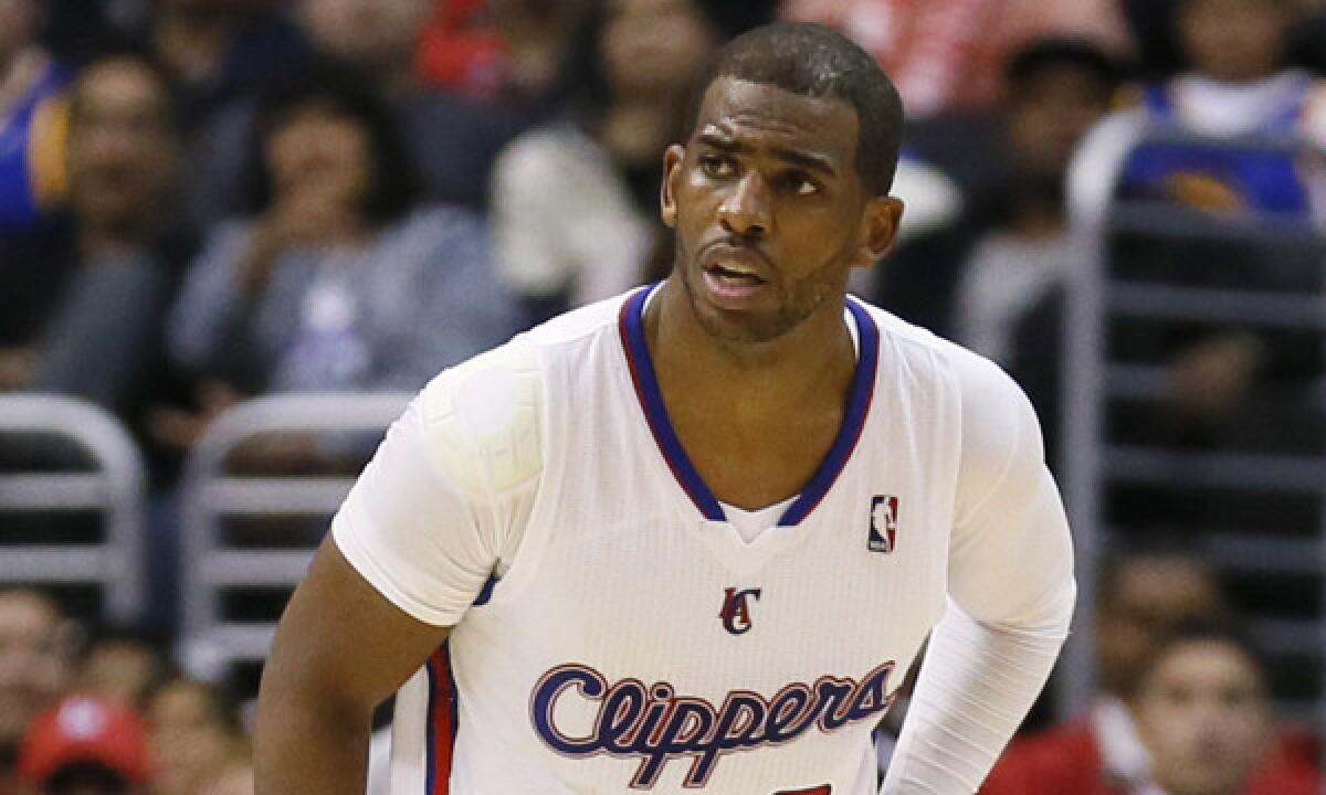 Clippers point guard Chris Paul holds his side after colliding with Golden State's Draymond Green (not pictured) during Wednesday's win. Paul suffered a left ankle injury in Friday's win over the Utah Jazz.