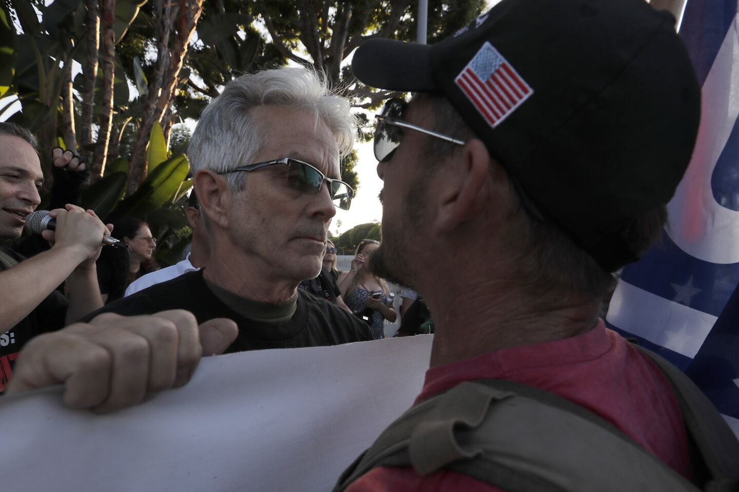 A supporter of President Trump, right, goes face to face with anti-Trump protesters in Beverly Hills.