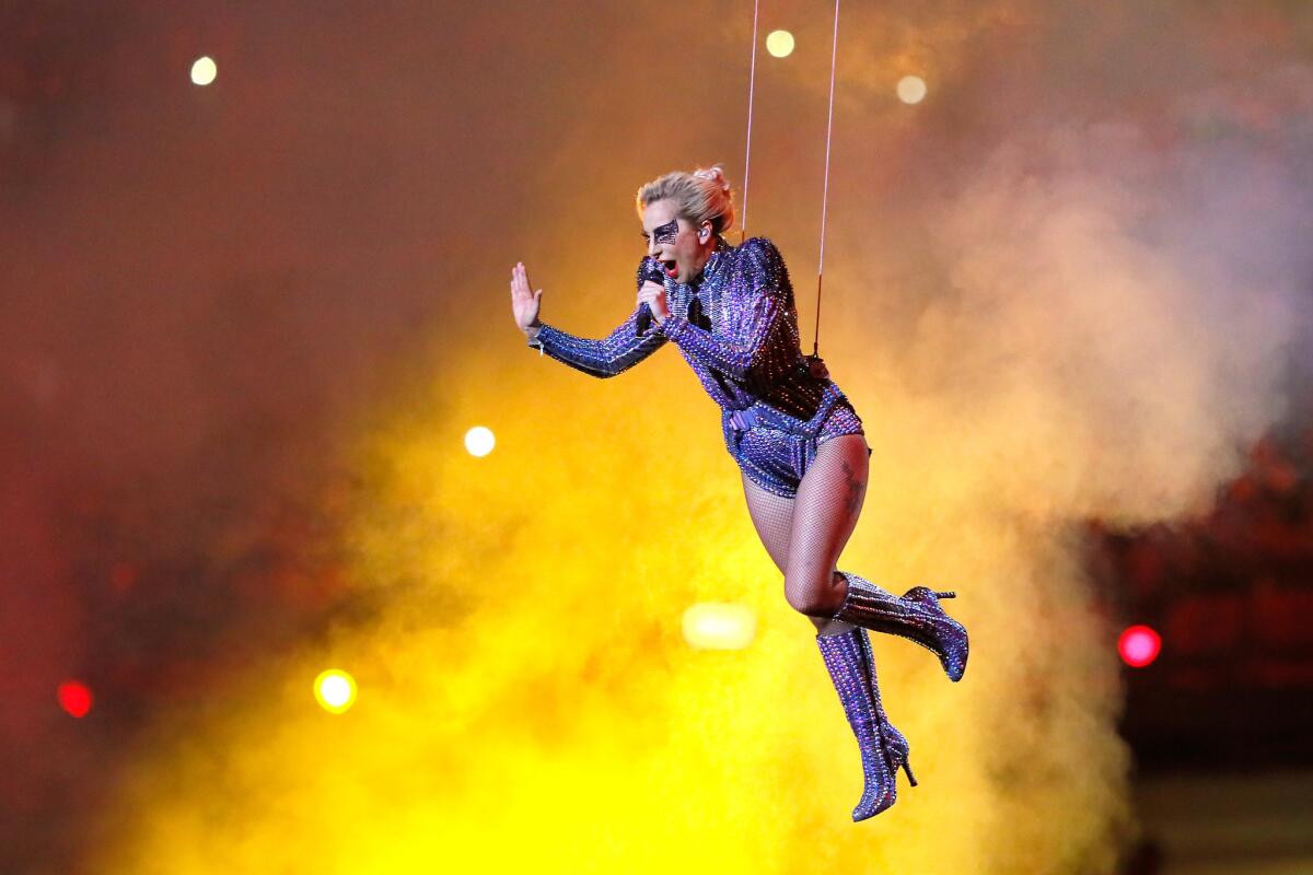 Lady Gaga flies through the air mid-song during her halftime show.