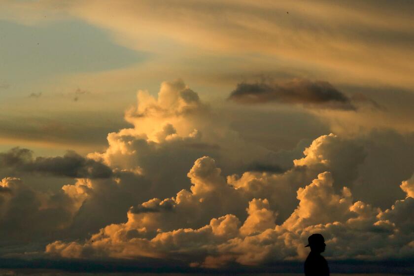 LONG BEACH, CALIF. - MAR. 11, 2021. Storm clouds blow over the Los Angeles Basin as a cold front moves through Southern California on Thursday, Mar. 11, 2021. (Luis Sinco/Los Angeles Times)