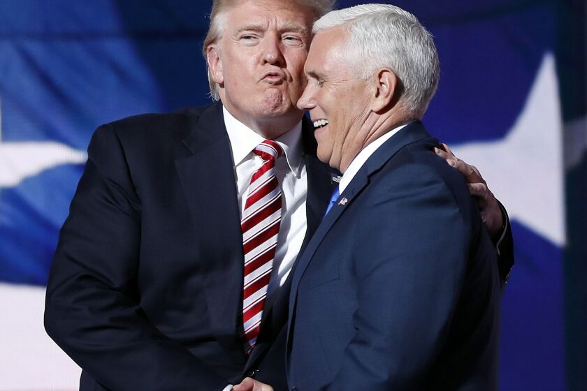 Republican presidential Candidate Donald Trump gives his running mate, Republican vice presidential nominee Gov. Mike Pence of Indiana a kiss as they shake hands after Pence's acceptance speech during the third day session of the Republican National Convention in Cleveland, Wednesday, July 20, 2016. (AP Photo/Mary Altaffer)