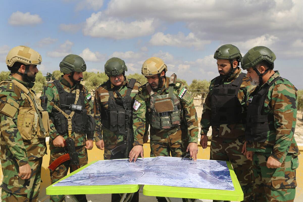 Members of the Turkish-backed Syrian National Army take part in military maneuvers near Azaz, Syria, on Oct. 7.