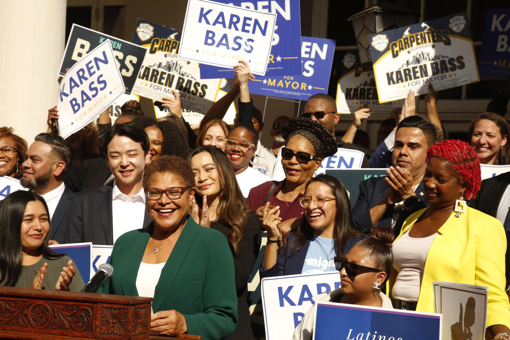 L.A. Mayor-elect Karen Bass addresses the media in front of happy supporters at Wilshire Ebell Theatre.