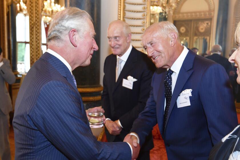 FILE - Britain's Prince Charles, left, shakes hand with Len Goodman, during a reception for Age UK at Buckingham Palace in London, June 6, 2018. Len Goodman, an urbane long-serving judge on “Dancing with the Stars” and “Strictly Come Dancing,” has died, his agent said Monday, April 24, 2023. He was 78. A former dancer, Goodman was a judge on “Strictly Come Dancing” for 12 years from its launch on the BBC in 2004. (John Stillwell/PA via AP, File)