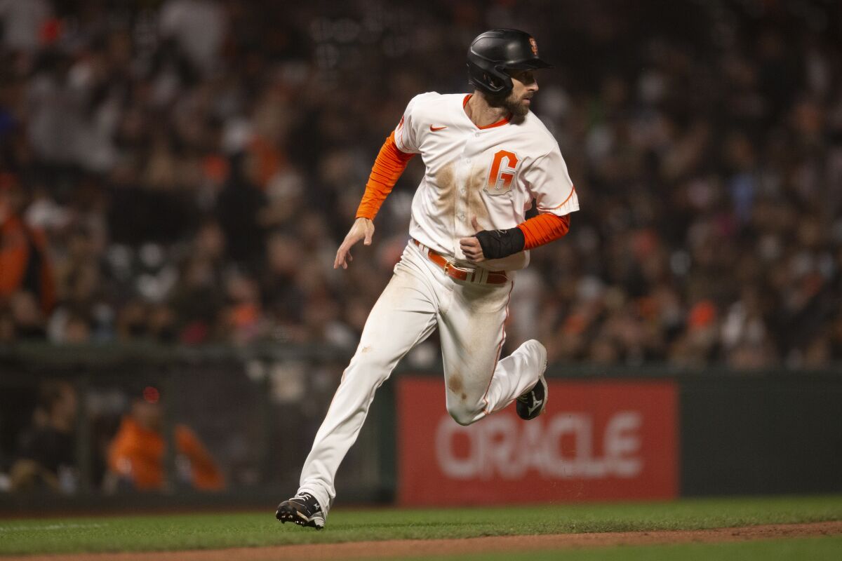 San Francisco Giants' Steven Duggar rounds third and heads for home on an RBI single by Tommy LaStella against the San Diego Padres during the fourth inning of a baseball game Tuesday, Sept. 14, 2021, in San Francisco. (AP Photo/D. Ross Cameron)