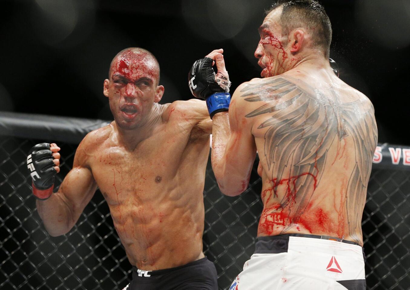 Edson Barboza, left, hits Tony Ferguson in a lightweight bout during The Ultimate Fighter finale Friday, Dec. 11, 2015, in Las Vegas. (AP Photo/John Locher)