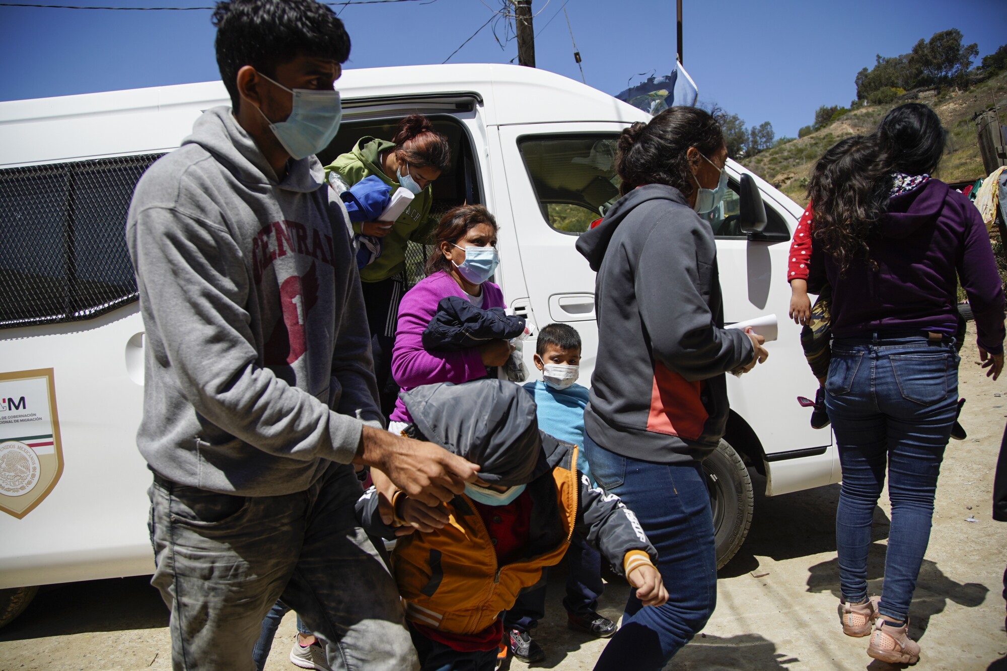 A Mexican government van drops off asylum seekers in Tijuana