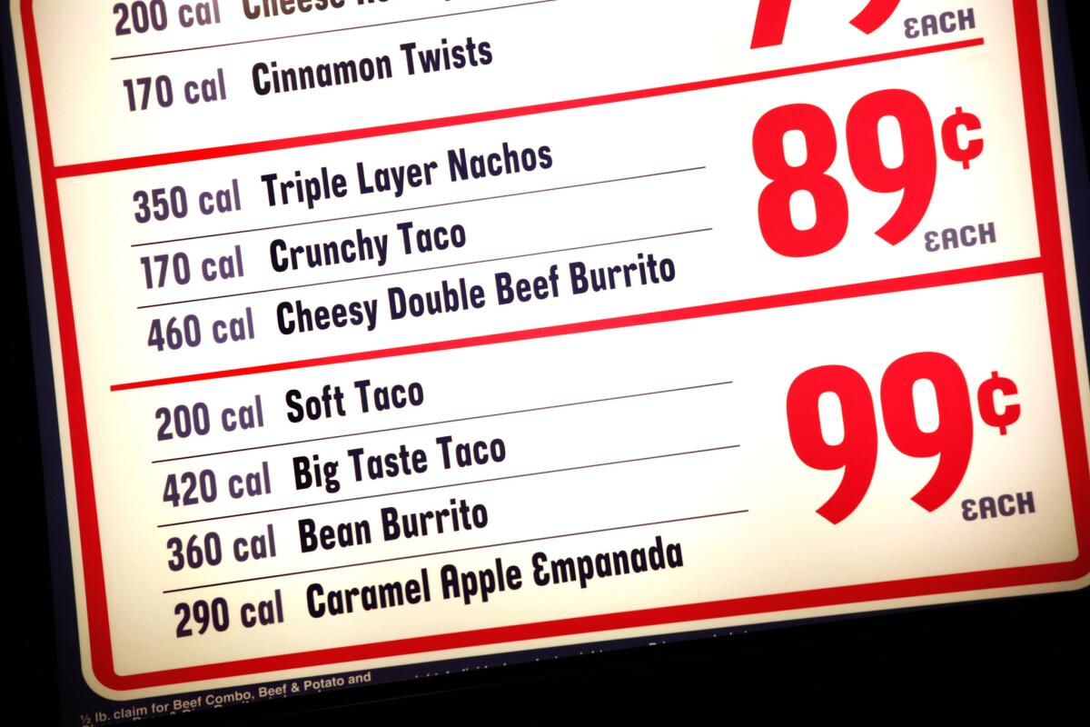 New FDA rules will require chain restaurants, movie theaters, bars and vending machines to clearly display calorie counts for items. Pictured is a menu at a Taco Bell in Flushing, N.Y.