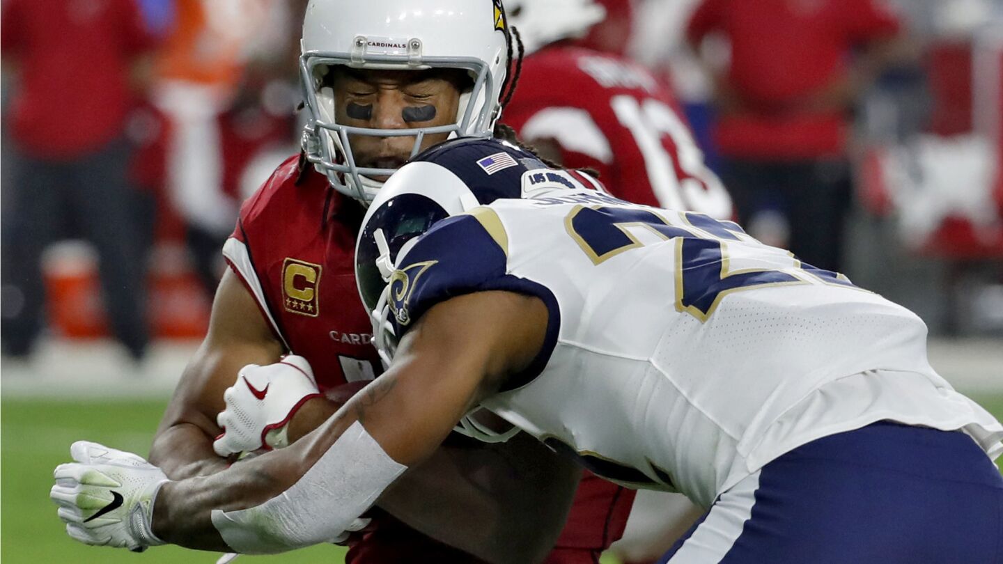 Cardinals wide receiver Larry Fitzgerald is hit from Rams cornerback Trumaine Johnson during the second half.