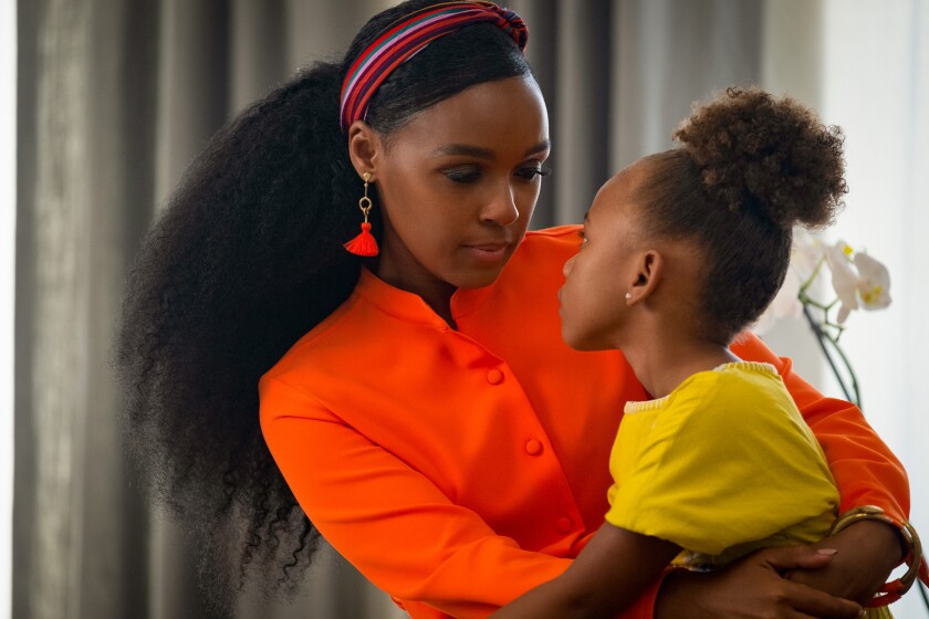 Janelle Monáe, left, holds young London Boyce in "Antebellum."