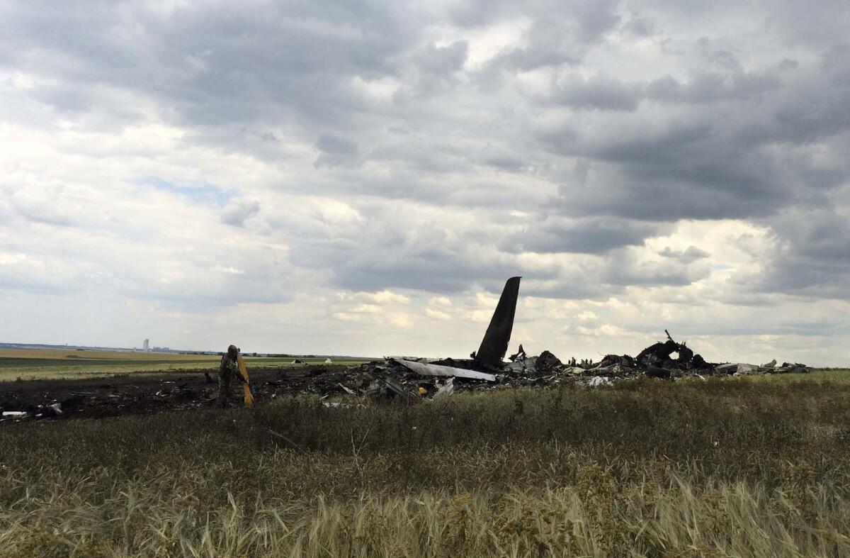 Remnants of a downed Ukrainian army aircraft lie at the airport near Luhansk.