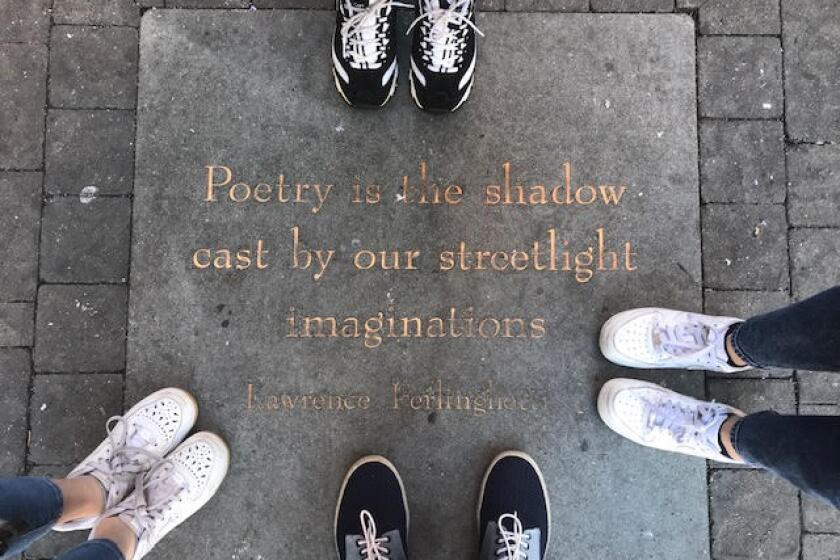 A family poses outside City Lights Bookstore in San Francisco on Jan. 2, 2020.