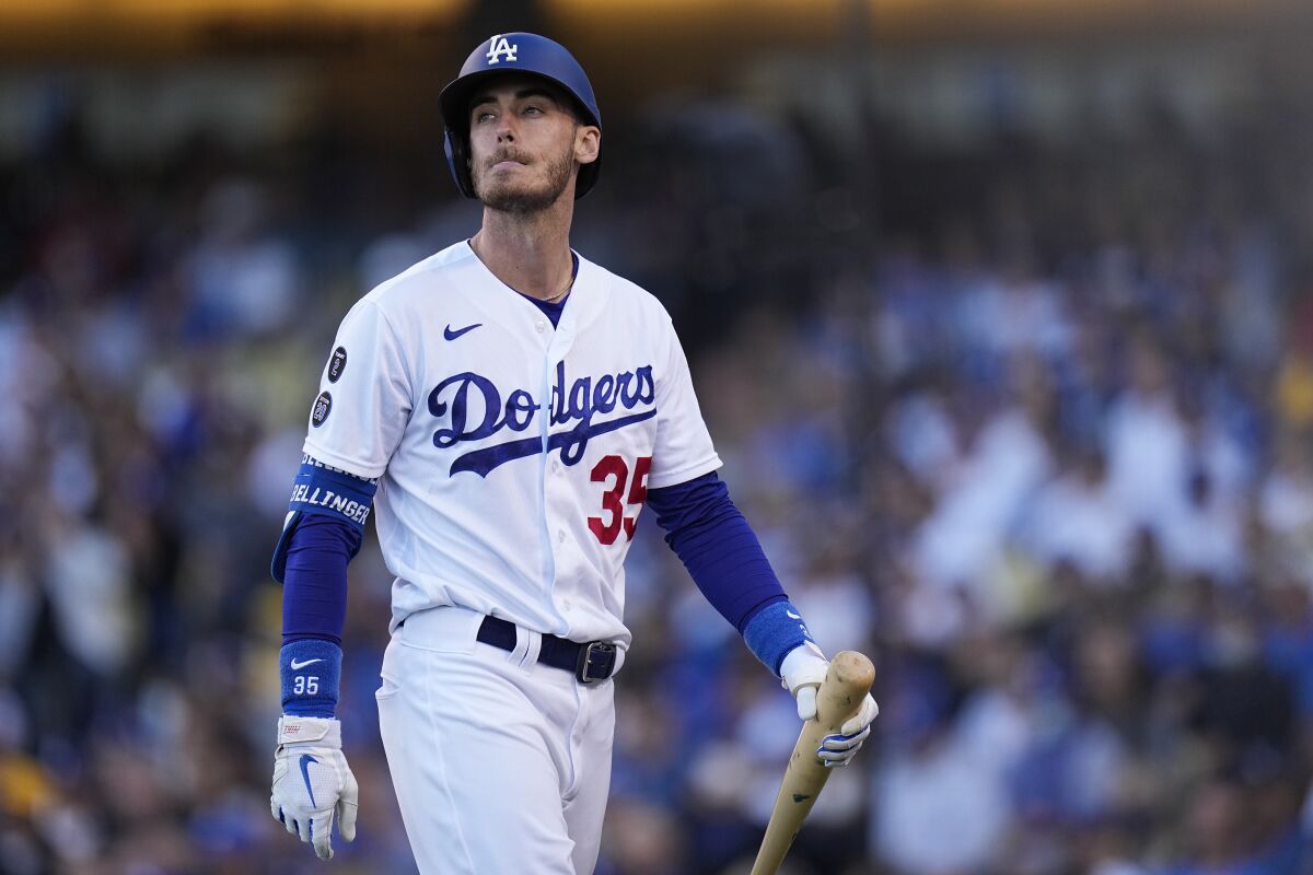 Dodgers center fielder Cody Bellinger walks off the field after striking out.