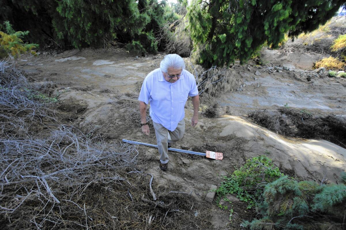 Herman "TJ" Laffoon, a council member of the Colorado River Indian Tribes, steps over a reservation property boundary sign that was knocked down by squatters in December.