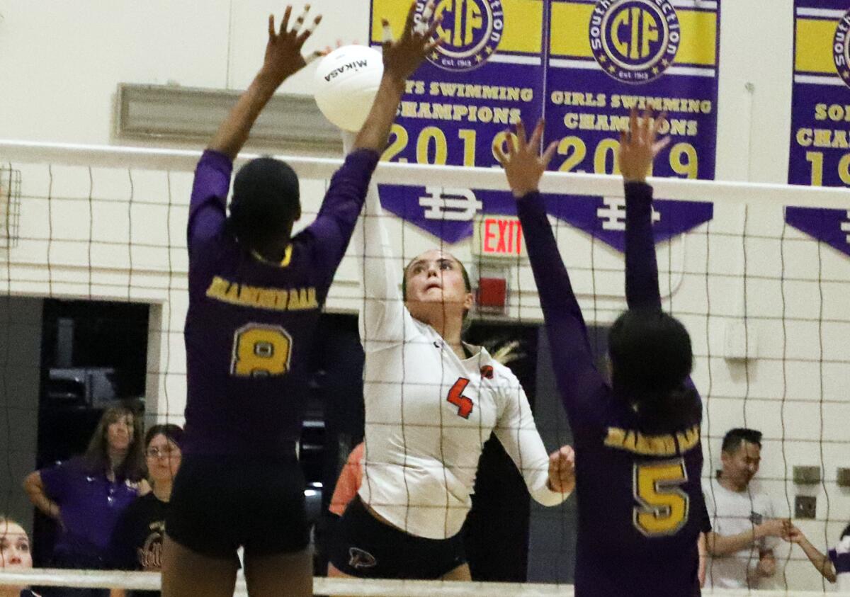 Pacifica Christian's Kaelin Rieke (4) tries to spike past Diamond Bar's Zariah Crosby (8) on Thursday.