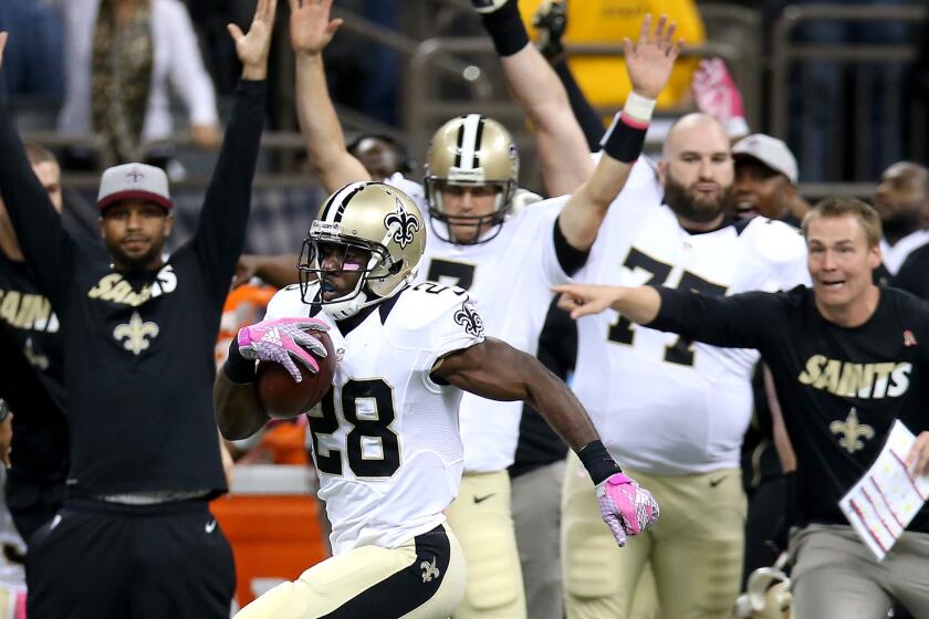 Saints running back C.J. Spiller (28) heads to the end zone on an 80-yard pass play in a 26-20 overtime win against the Cowboys on Sunday.