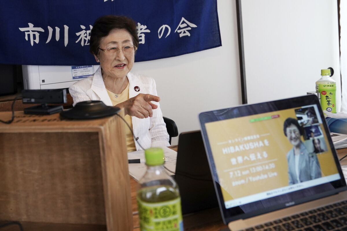 Michiko Kodama, assistant secretary-general of the Japan Confederation of A and H Bomb Sufferers' Organizations, prepares to narrate her experience on a livestream of "Kataribe" or story-telling session Sunday, July 12, 2020, in Tokyo. “For me, the war is not over yet,” said Michiko Kodama, 82, who survived the bombing but has lost most of her relatives from cancer, including one of her two daughters. Years after the atomic bombing, a receptionist at a clinic near Tokyo noted Kodama's “hibakusha” medical certificate in a loud voice, and a patient sitting next to her in a waiting room moved away from her. The fear of death, prejudice and discrimination at work and in marriage continues, and nuclear weapons still exist. (AP Photo/Eugene Hoshiko)