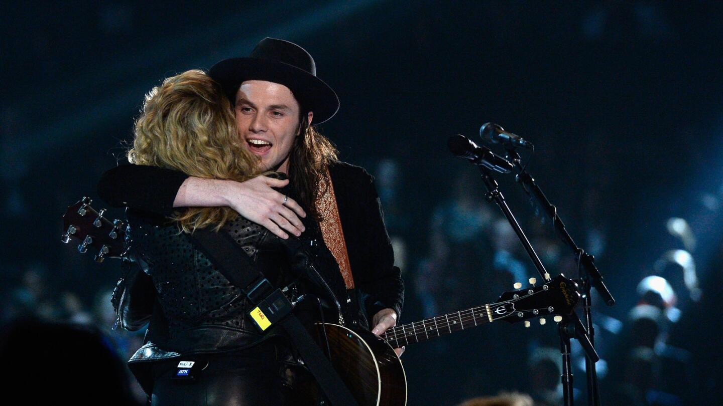Tori Kelly, left, and James Bay embrace after perfoming a rendition of their songs "Hollow" and "Let It Go."