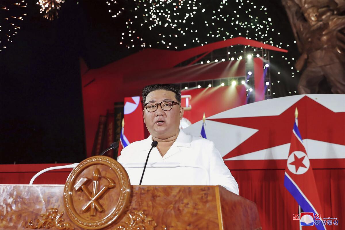 Kim Jong Un speaks at a lectern.