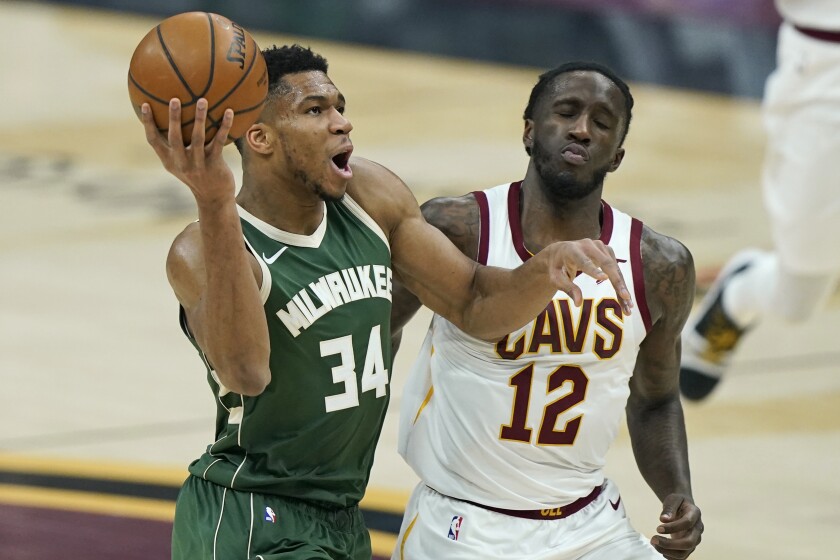Milwaukee Bucks' Giannis Antetokounmpo (34) drives to the basket against Cleveland Cavaliers' Taurean Prince (12) in the first half of an NBA basketball game, Saturday, Feb. 6, 2021, in Cleveland. (AP Photo/Tony Dejak)