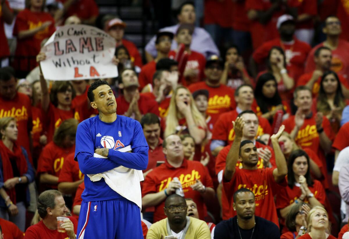 Clippers forward Matt Barnes checks the scoreboard as Houston fans cheer as the Rockets build a big lead in the fourth quarter of Game 7.