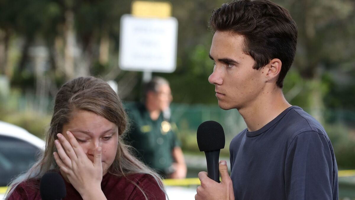 Students Kelsey Friend, left, and David Hogg speak about the mass shooting at Marjory Stoneman Douglas High School on Feb. 15, 2018.