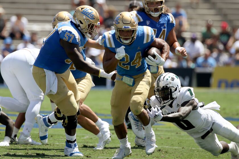 PASADENA, CALIF. - AUG. 28, 2021. UCLA running back Zach Charbonnet breaks free for a touchdown.