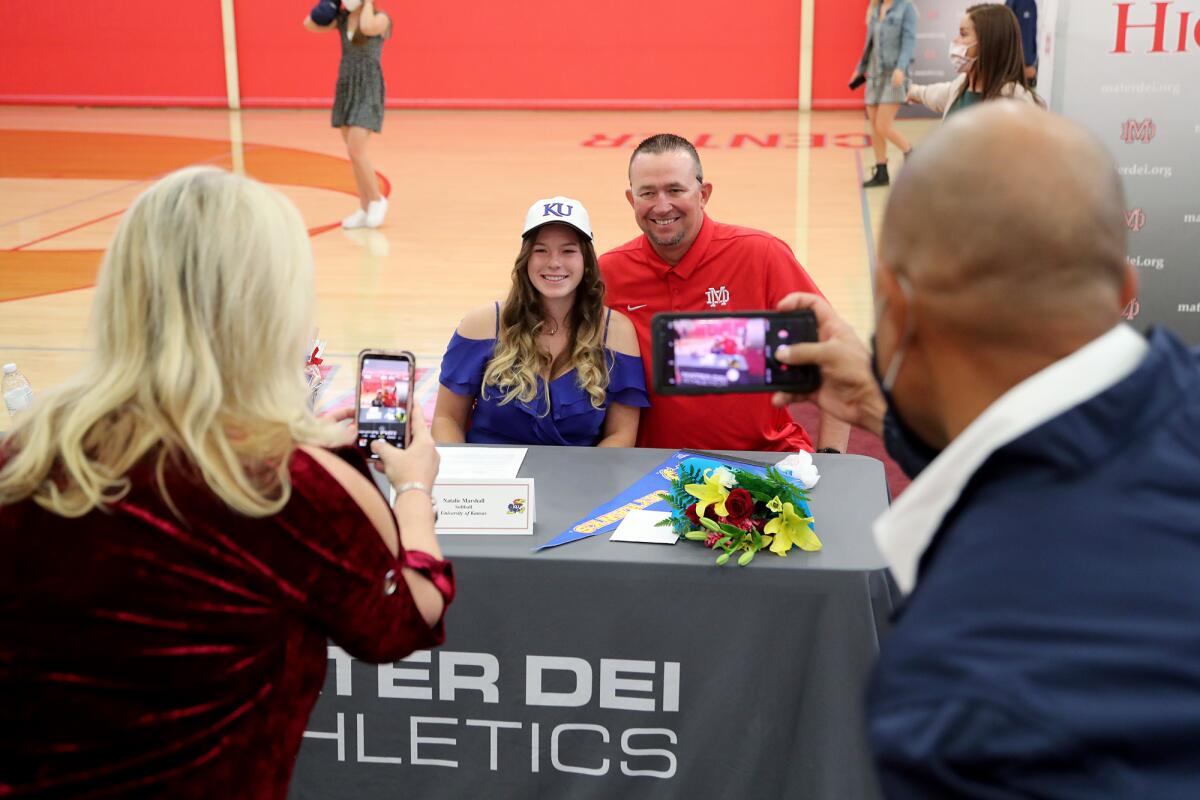 Senior Natalie Marshall, of Huntington Beach, smiles for a picture with softball coach Sean Brashear during Signing Day.