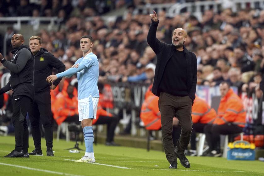 Manchester City manager Pep Guardiola, right, gestures during the English League Cup soccer match between Newcastle United and Manchester City in Newcastle upon Tyne, England, Wednesday, Sept. 27, 2023. (Owen Humphreys/PA via AP)