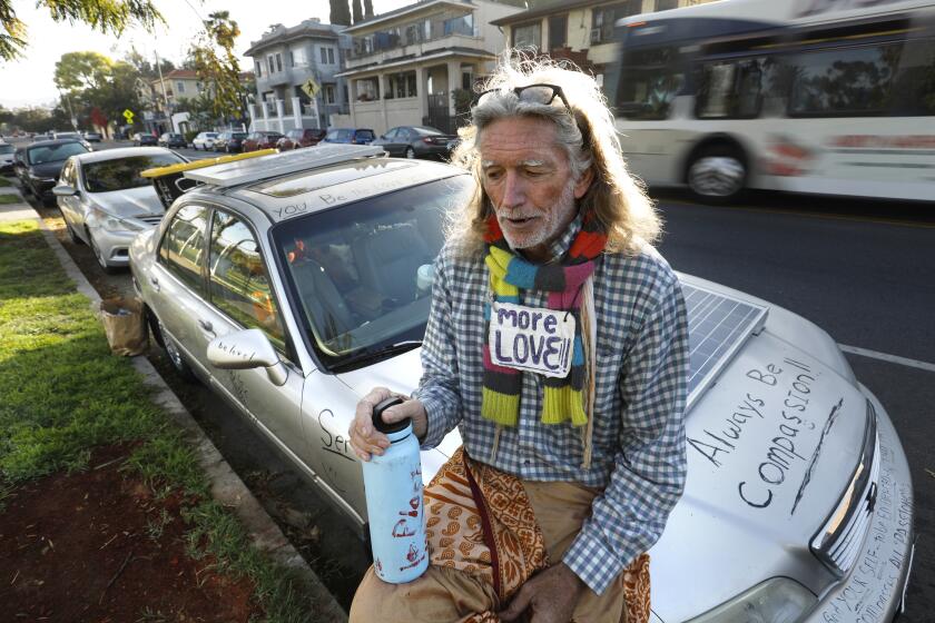 Los Angeles, California-March 18, 2022 -Echo Park was cleared of homeless in March 2021. On the one-year anniversary, David Busch-Lilly, age 66, who was living inside the park, now lives in his car on Echo Park Ave. March 25, 2022. (Carolyn Cole / Los Angeles Times)